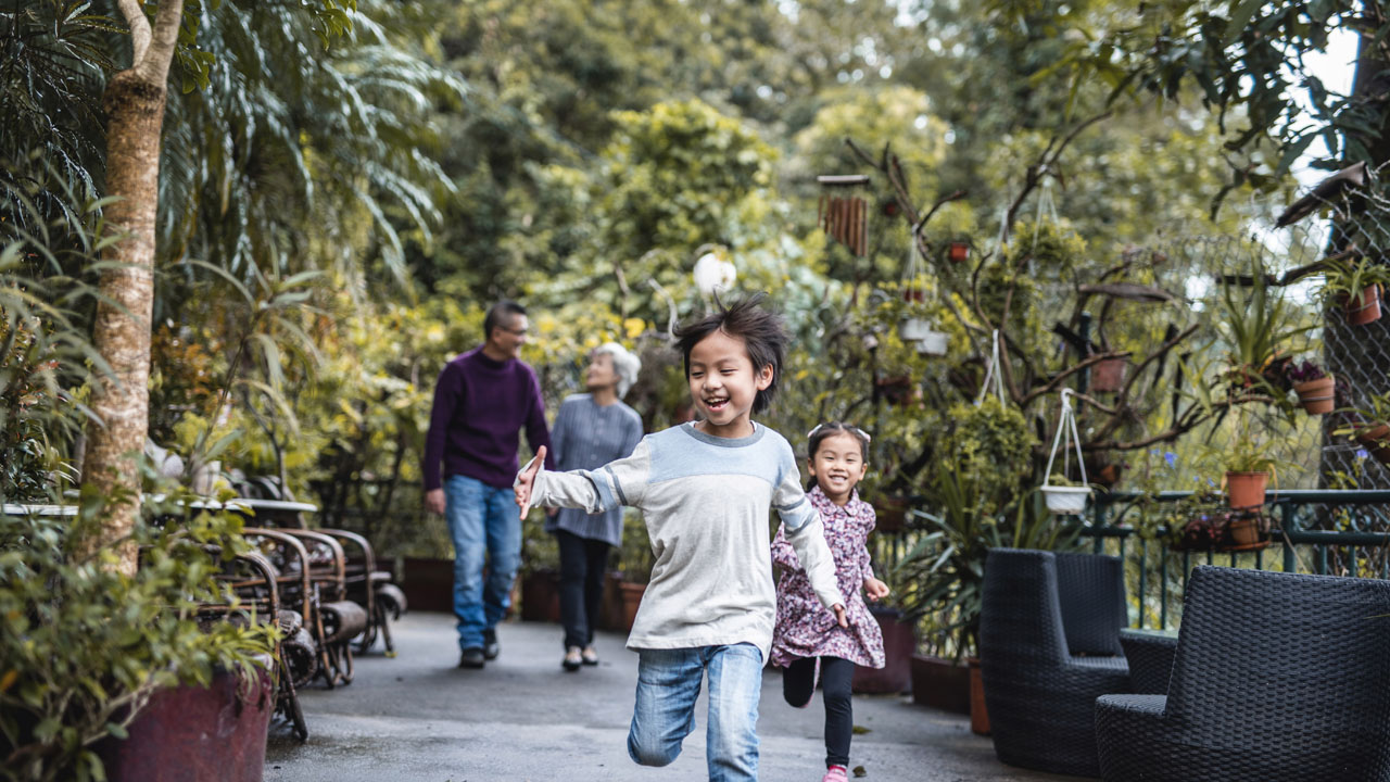 Boy running ahead of his parents